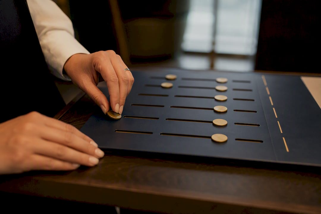 Hands marking attendance tokens